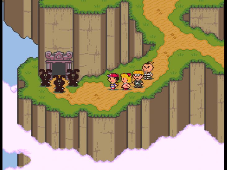 Ness and his friends approach the rabbit statues blocking the entrance to the cave in Dalaam.