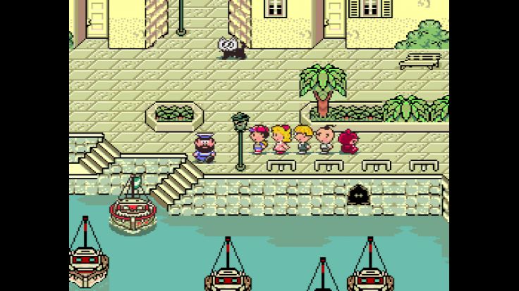 Ness and his friends prepare to depart from the port town of Toto to reach Scaraba.